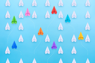 Wall Mural - Group of paper planes in one direction and with one group individual pointing in the different way. New idea, different vision creative, Unique way and Business for innovative solution concept.