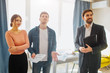 © estradaanton - Couple buy or rent apartment together. They stand with realtor. Young man look up. Woman has doubts. Cheerful realtor look rorward.