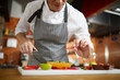 © Seventyfour - Mid section portrait of unrecognizable chef cutting vegetables in restaurant, copy space