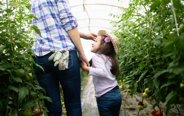 Mother and daughter working in the farm.