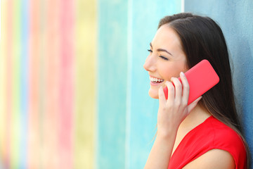 Sticker - Profile of a woman talking on phone leaning in a colorful wall