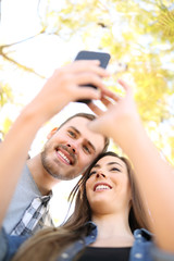 Sticker - Happy couple are using a smart phone in a park