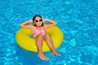 © SuperCoolPhotography - Real adorable girl relaxing in swimming pool