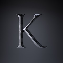 Chiseled iron letter K uppercase. 3d render game or movie title font isolated on black background.