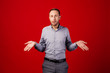 man with confused. emotions, facial expressions, feelings, body language, signs. image on a red studio background