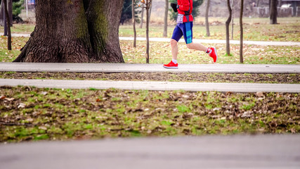 Wall Mural - Runner with race number  in the park in winter