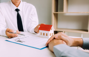 Wall Mural - Home agents are sending pens to customers signing a contract to buy a new home.