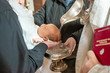 Infant baptism. Baptism ceremony in Church. Water is poured on the head of an infant