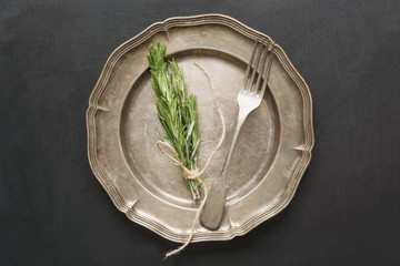 Wall Mural - Vintage table place setting with rosemary on black. Top view. Concept. Minimalism