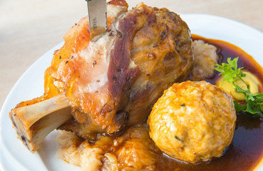 Wall Mural - Traditional Bavarian roast pork knuckle with dumplings.