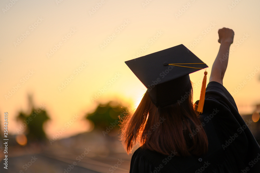 Graduates wear a black dress, black hat at the university level. - obrazy, fototapety, plakaty 