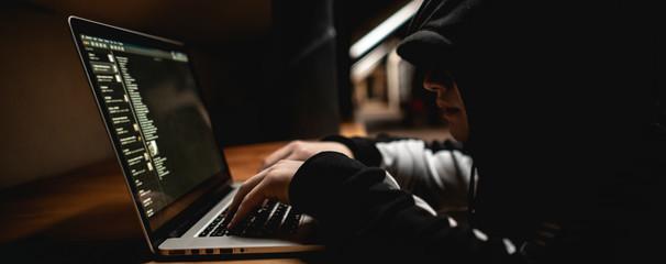 male hacker using laptop, breaking the government servers with personal data f