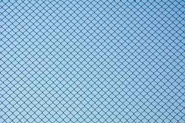 Canvas Print - Wire mesh steel on blue sky background