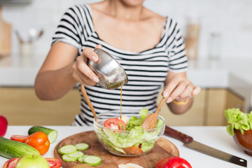 Healthy food Asian woman is cooking salad in kitchen, female preparing the vegetables and fruit at her house