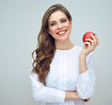 Woman With Toothy Smile Wearing White Shirt Holding Red Apple.