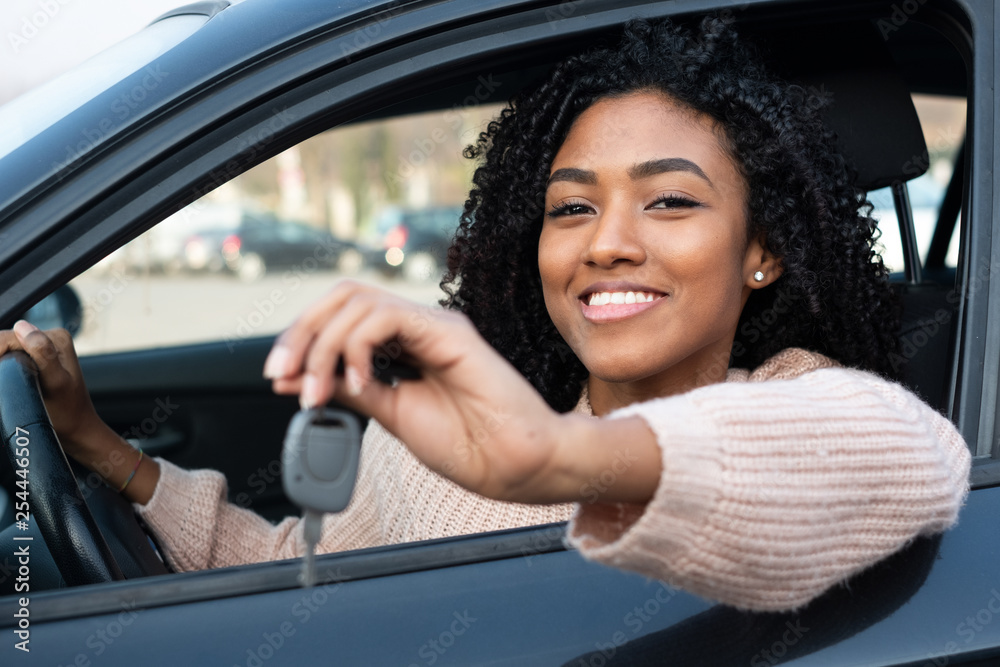 Happy young woman learning to drive car - obrazy, fototapety, plakaty 