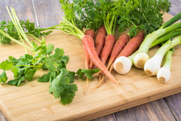 Wall Mural - Pink fresh organic carrots, green onion, cilantro.