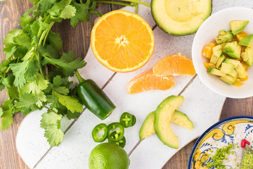 Wall Mural - Ingredients for orange avocado salsa.