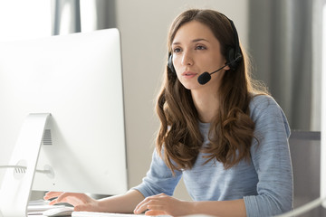 Wall Mural - Businesswoman in headset call center agent consulting participating video conference