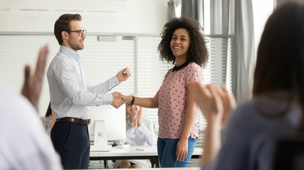 Wall Mural - helpful boss handshaking happy african employee congratulating promoting rewarding worker