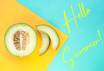 Canvas Print - Flat lay of sweet ripe melon and its slices on blue and yellow background with copyspace.