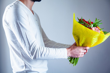 Wall Mural - man hand holding flowers bouquet