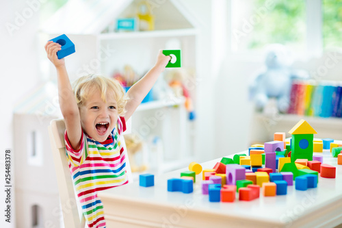 Naklejki do przedszkola kids-toys-child-building-tower-of-toy-blocks