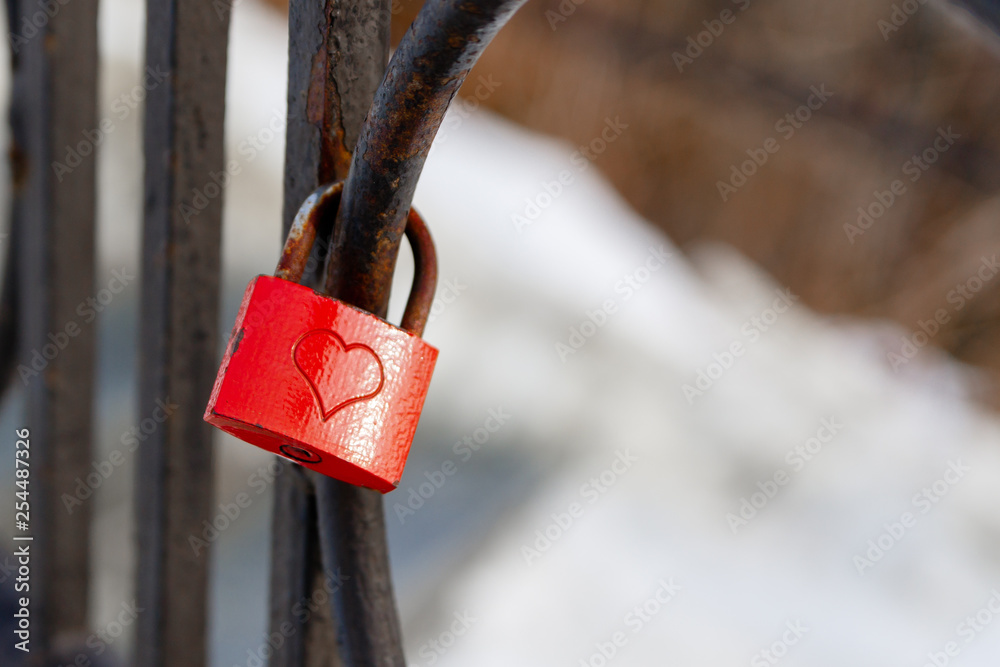 Red love padlock attached to steel fence. Rusty lock with heart shape ...