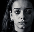 © SB Arts Media - Sad young girl crying and suffering harassment online. Cyberbullying and dangers of internet.