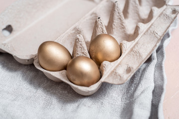 photo of three golden eggs on grass to represent wealth and luck