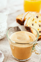 Wall Mural - Continental breakfast table with cup of hot  coffee with milk, cakes and orange juice