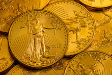 Pile Of Golden Coins With Liberty On US Treasury Issue Gold Eagle One Ounce Pure Gold Coin