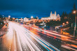 © Great Brut Here - Minsk, Belarus. Night Traffic On Illuminated Street And  Cathedral Of Holy Spirit In Minsk. Famous And Main Orthodox Church Of Belarus At Evening. Famous Landmark.