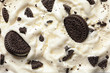 © New Africa - Tasty ice cream with chocolate sandwich cookies as background, top view