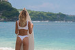 © South House Studio - sexy woman in bikini poses on beach at blue tropical ocean, surfboard in hands,