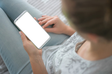 Wall Mural - holding mobile phone white screen woman's hands smartphone. Mockup image of smart phone. chroma key. close up.