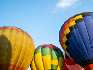 Close up colorful hot air balloons on blue sky.