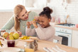 © Viacheslav Yakobchuk - Mother and daughter having much fun cutting vegetables for salad