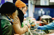 © Stay Art - Contactless payment. A man pays with a phone on the market. Checkout Counter Customer Pays with Smartphone for His Items. Modern Wireless Paying Terminal System