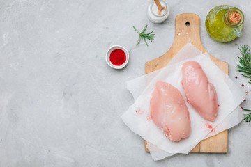 Raw chicken breast fillets with rosemary, red paprika and spices