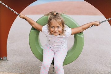 Happy positive girl playing in kindergarten, laughing and smiling. Childhood, active life, sport concept