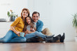 © Yakobchuk Olena - Happy smiling family sitting on floor together