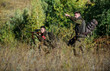 © be free - Teamwork and support. Activity for real men concept. Hunters gamekeepers looking for animal or bird. Hunting with friends. Hunters friends enjoy leisure. Hunters with rifles in nature environment