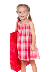 Wall Mural - Cute litle girl with red shopping bag isolated on a white background