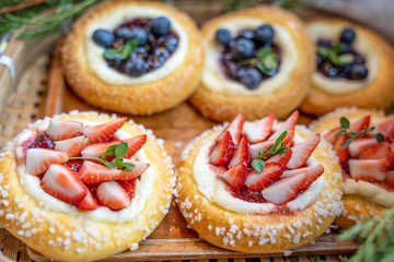 Sweet strawberry tart and blueberry tart on the table