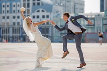 Bride And Groom In Wedding Attire Dancing Fiery Dance In The Town Square