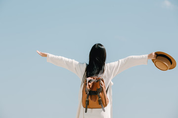 Wall Mural - Female tourists spread their arms and held their wings, smiling happily.