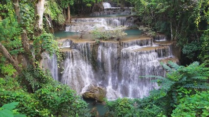Wall Mural - Waterfall flow standing with forest enviroment high angle view in thailand called Huay or Huai mae khamin in Kanchanaburi Provience, Thailand., tilt up.