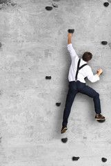 Businessman climbs the wall as a climber, business concept