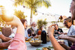 © Alessandro Biascioli - Happy family doing a dinner during sunset time outdoor - Group of diverse friends having fun dining together outside - Concept of lifestyle people, food and weekend activities